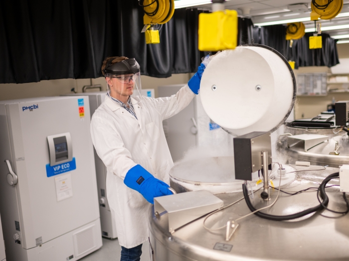 Photo of CBR staff member opening a liquid nitrogen tank