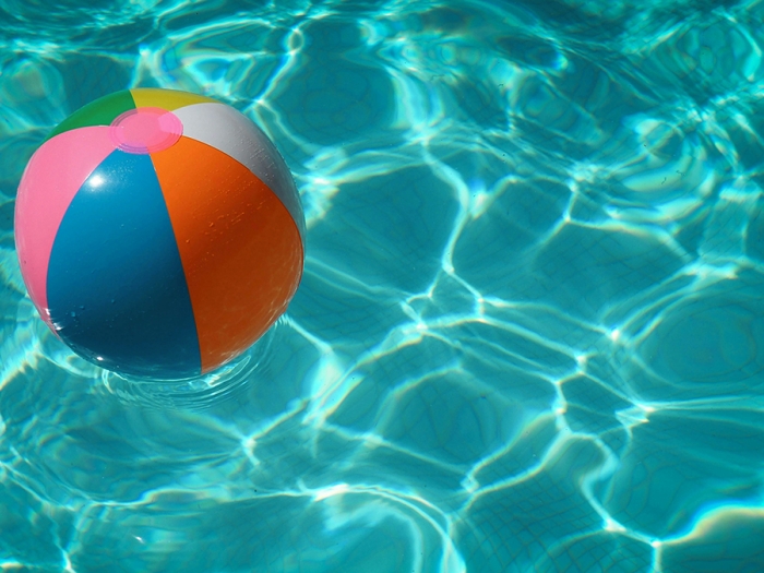 Colorful beach ball floating in a pool