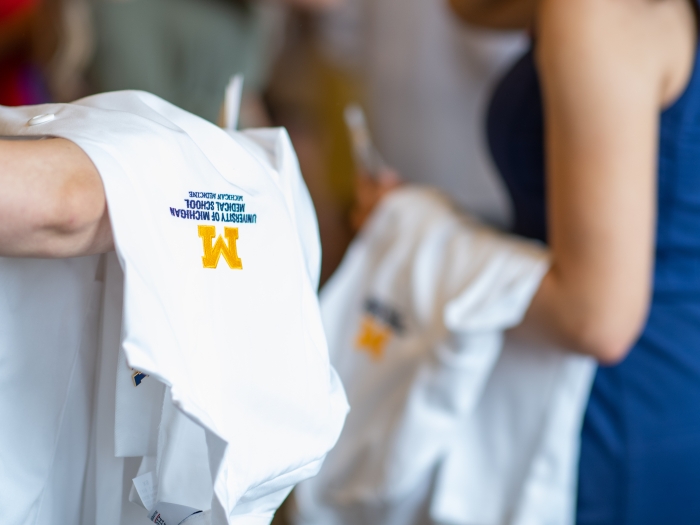 close-up image of the U-M logo on a white coat