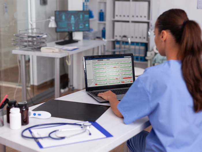 Nurse viewing AHI interface displayed on a laptop computer monitor.