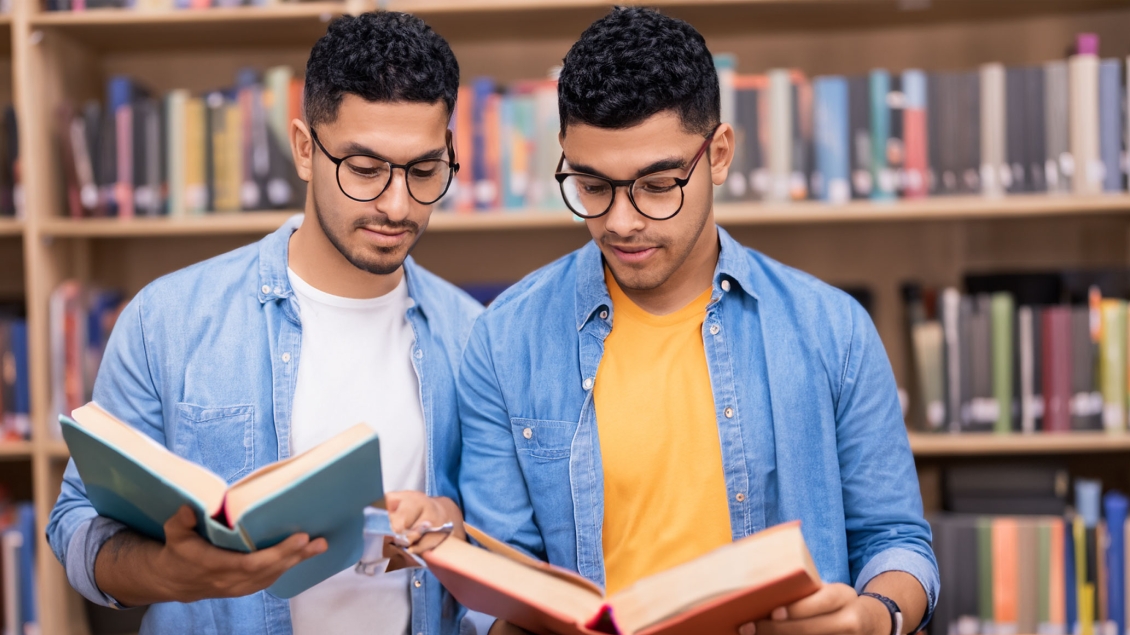 two guys reading in a library