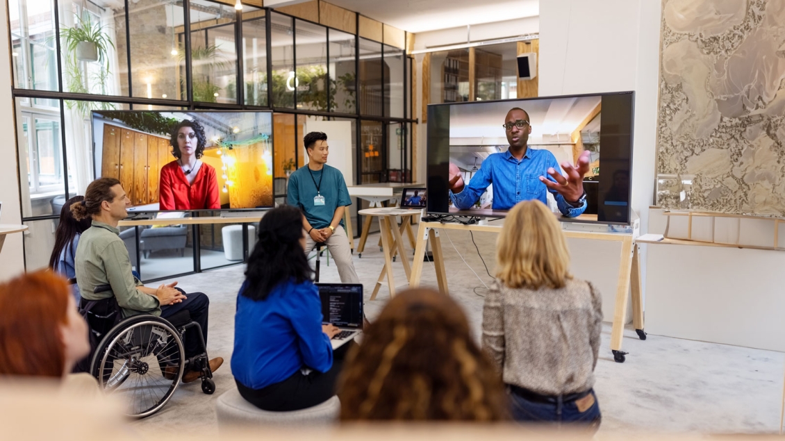 Group watching tv in art studio