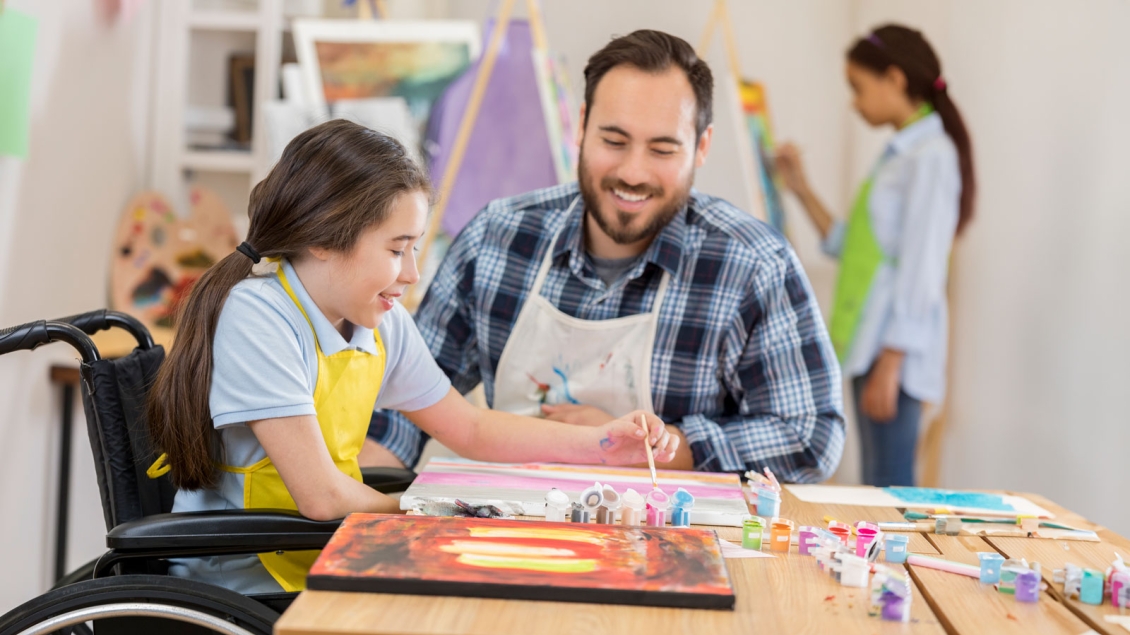 Young student in art class with dad