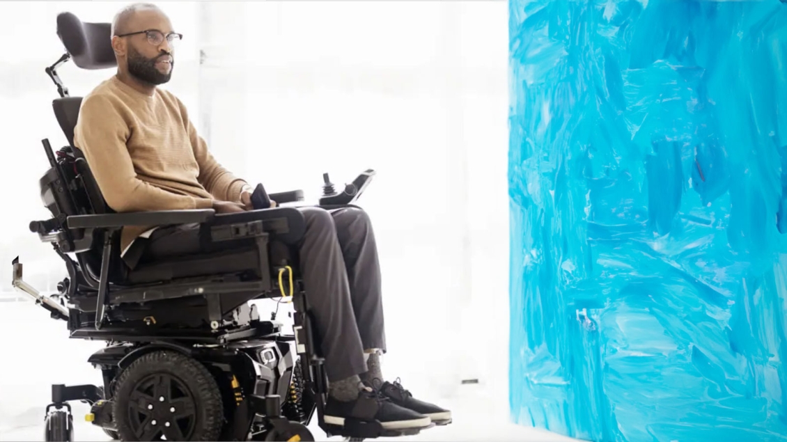 Man in Wheelchair looking at blue painting