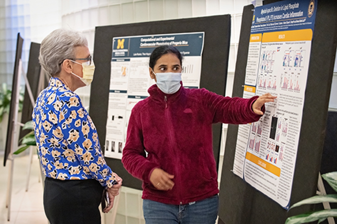 Two women discussing near the information board.