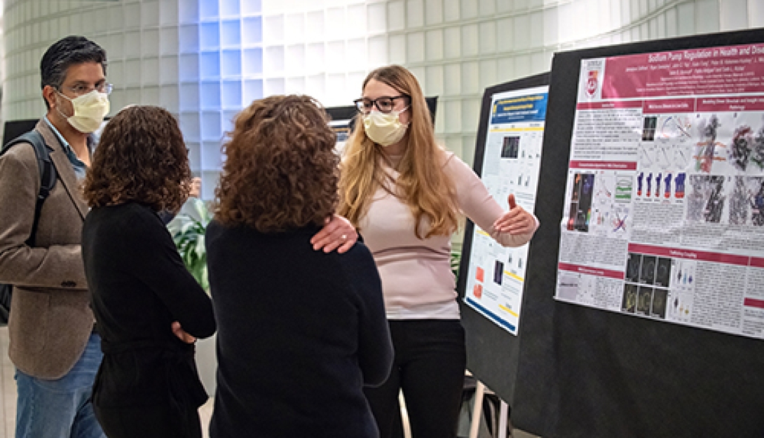 A group of people discussing near the information board.