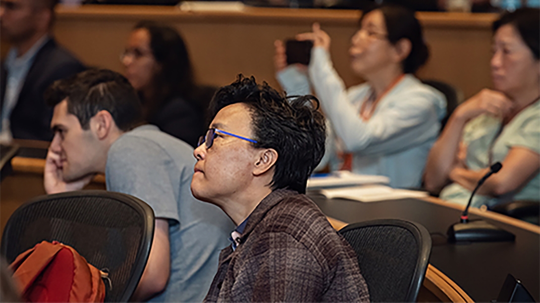 Audiences listening and taking pictures during Annual M-BoCA Symposium