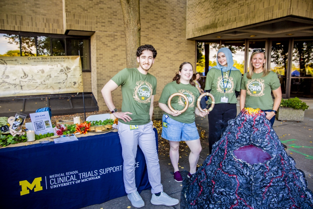 people posing at table at outdoor event