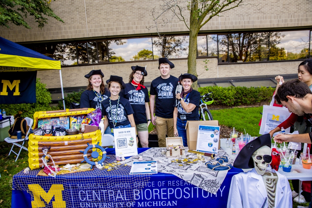 people posing at table at outdoor event