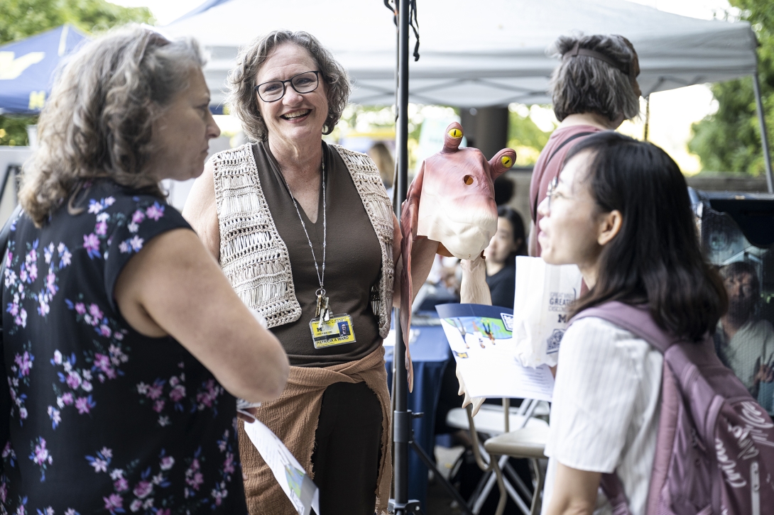 people talking at table at outdoor event