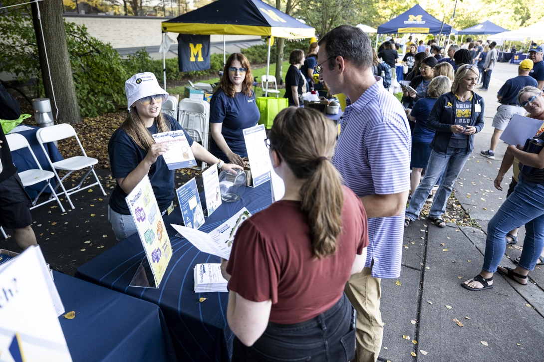 people talking at table at outdoor event