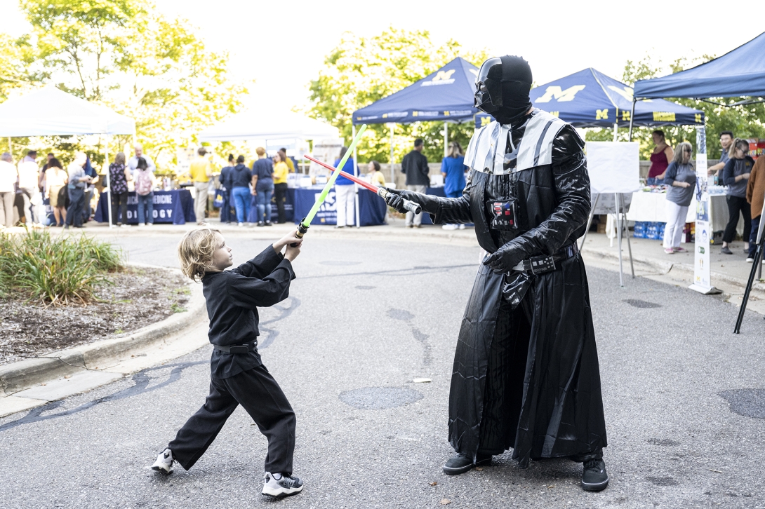 two people dressed in Star Wars costumes reenacting movie scenes