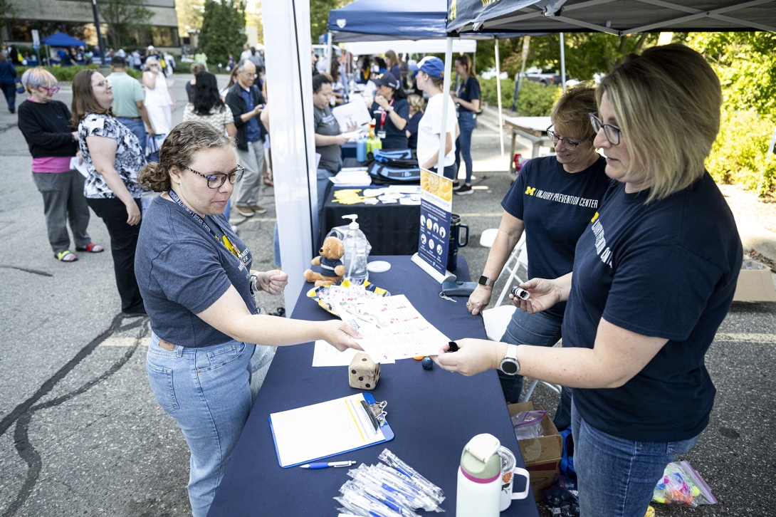 people talking at table at outdoor event