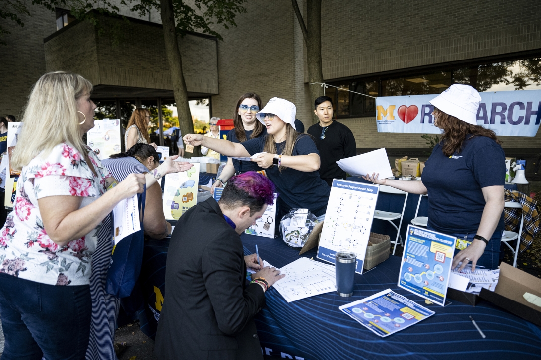 people talking at table at ourdoor event