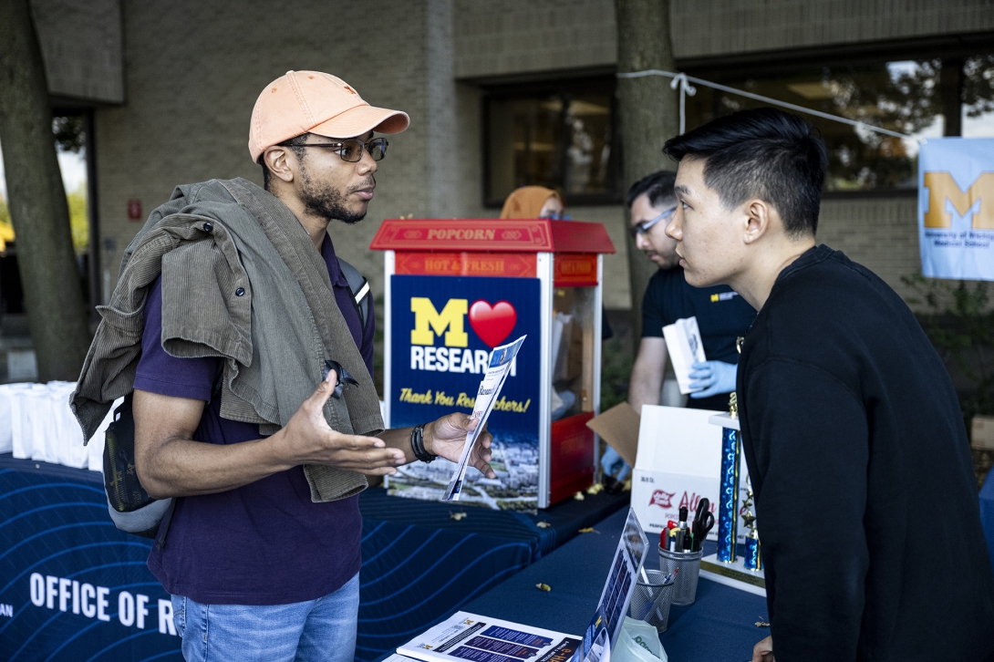 people talking at table at ourdoor event