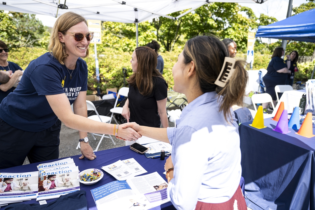 two people shaking hands at event